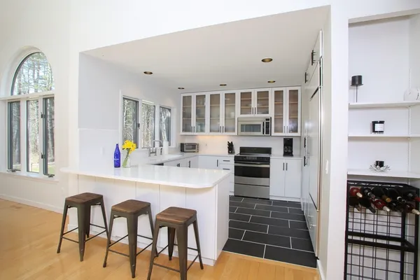 a kitchen with stainless steel appliances a stove sink and cabinets