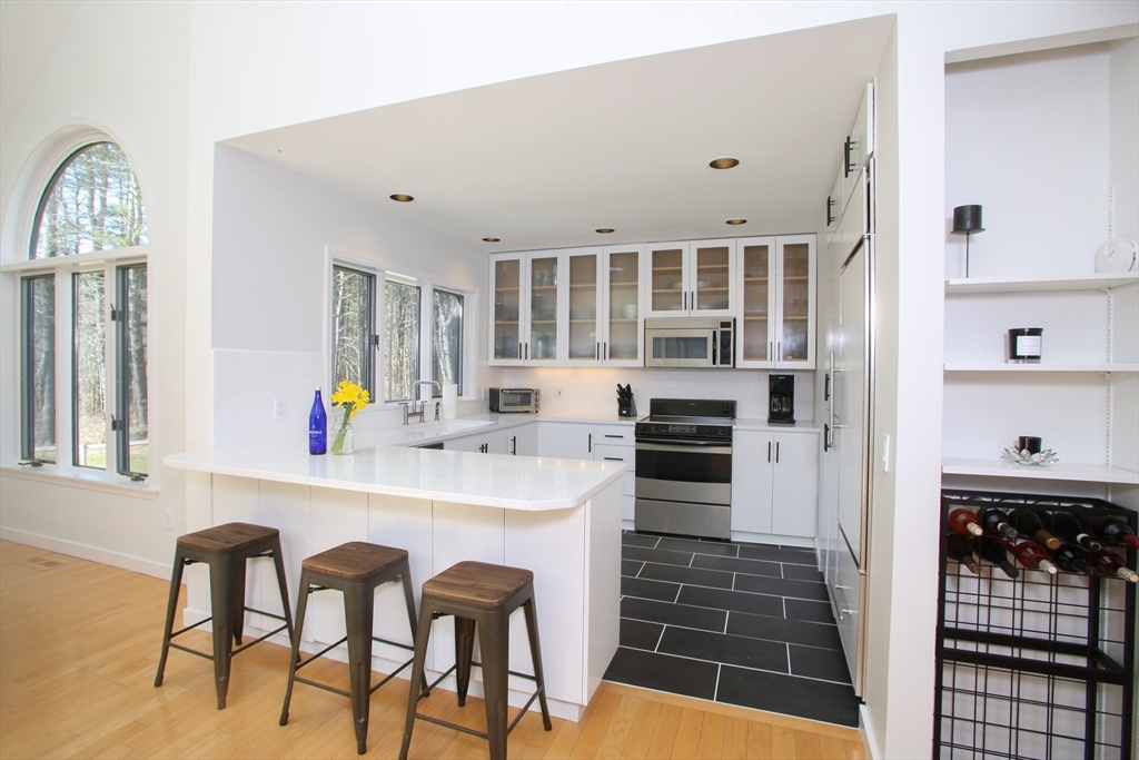 23 Cross Road Alford, MA 01230 - Photo 10 of 37 a kitchen with stainless steel appliances a stove a table and chairs