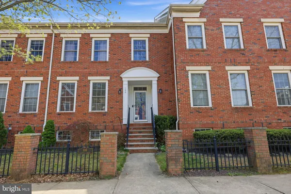 front view of a brick house with a small yard