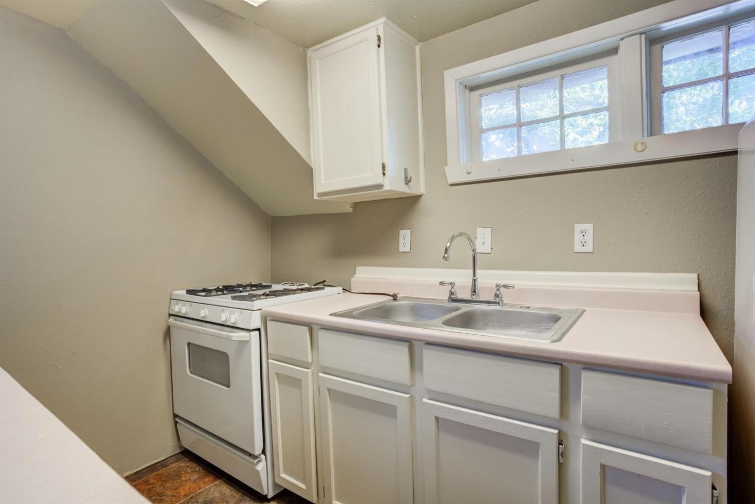 2702 20th Street Lubbock, TX 79410 - Photo 33 of 34 a kitchen with appliances a sink and cabinets