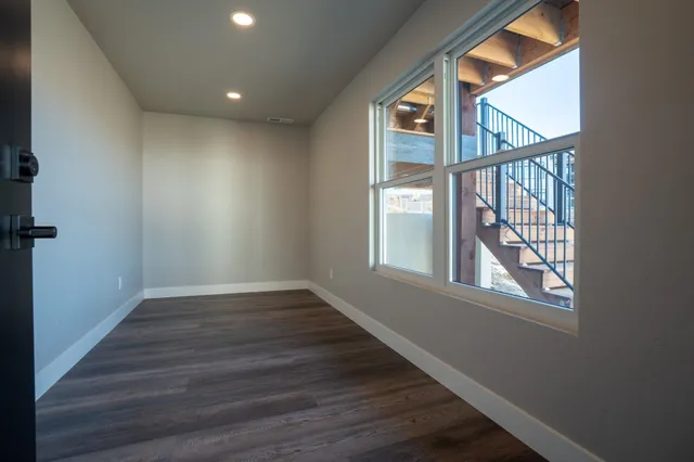 wooden floor in an empty room with a window