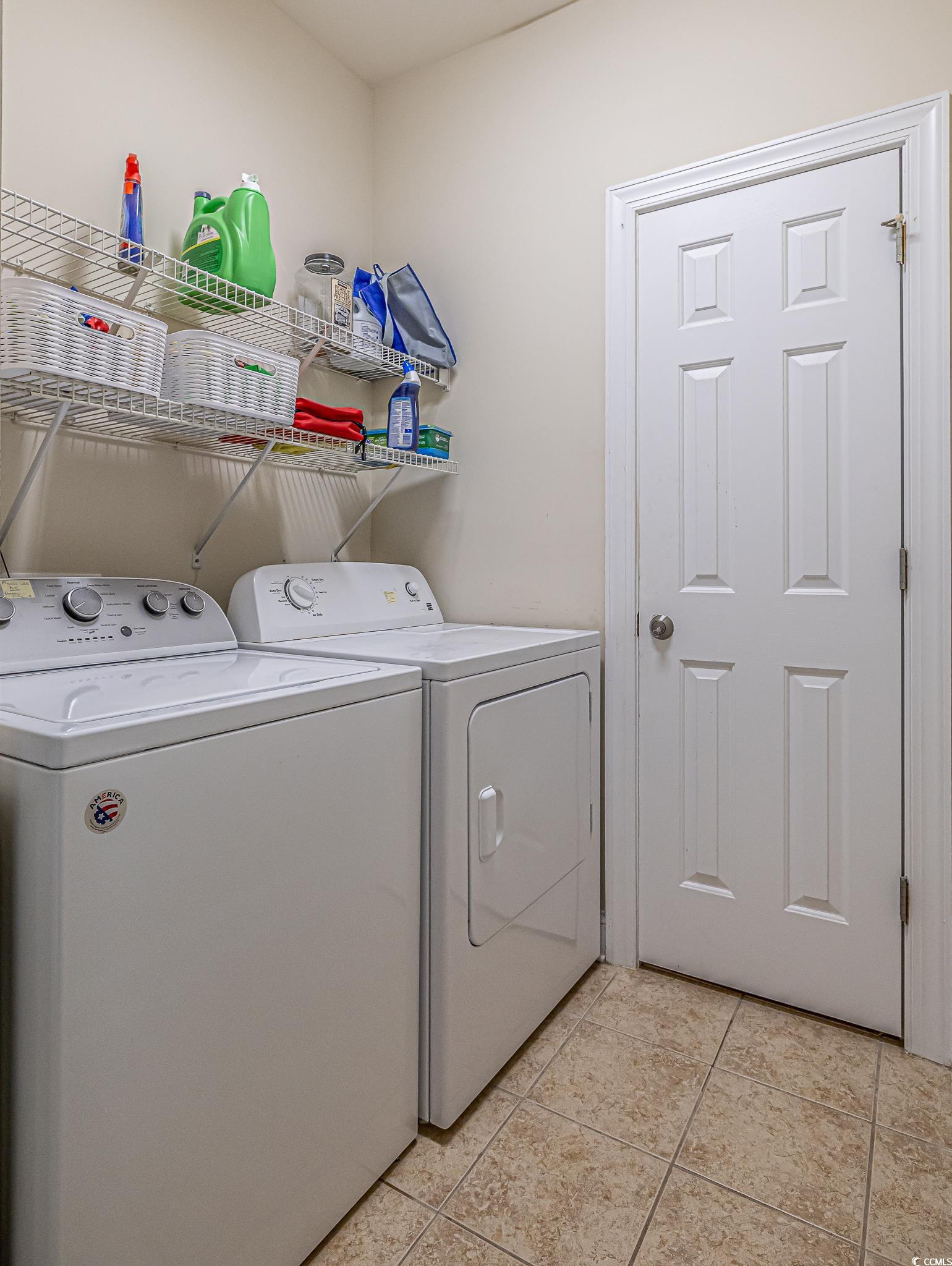 719 Shearwater Court, Unit 303 Murrells Inlet, SC 29576 - Photo 12 of 20 Laundry room featuring washing machine and clothes dryer and light tile patterned floors