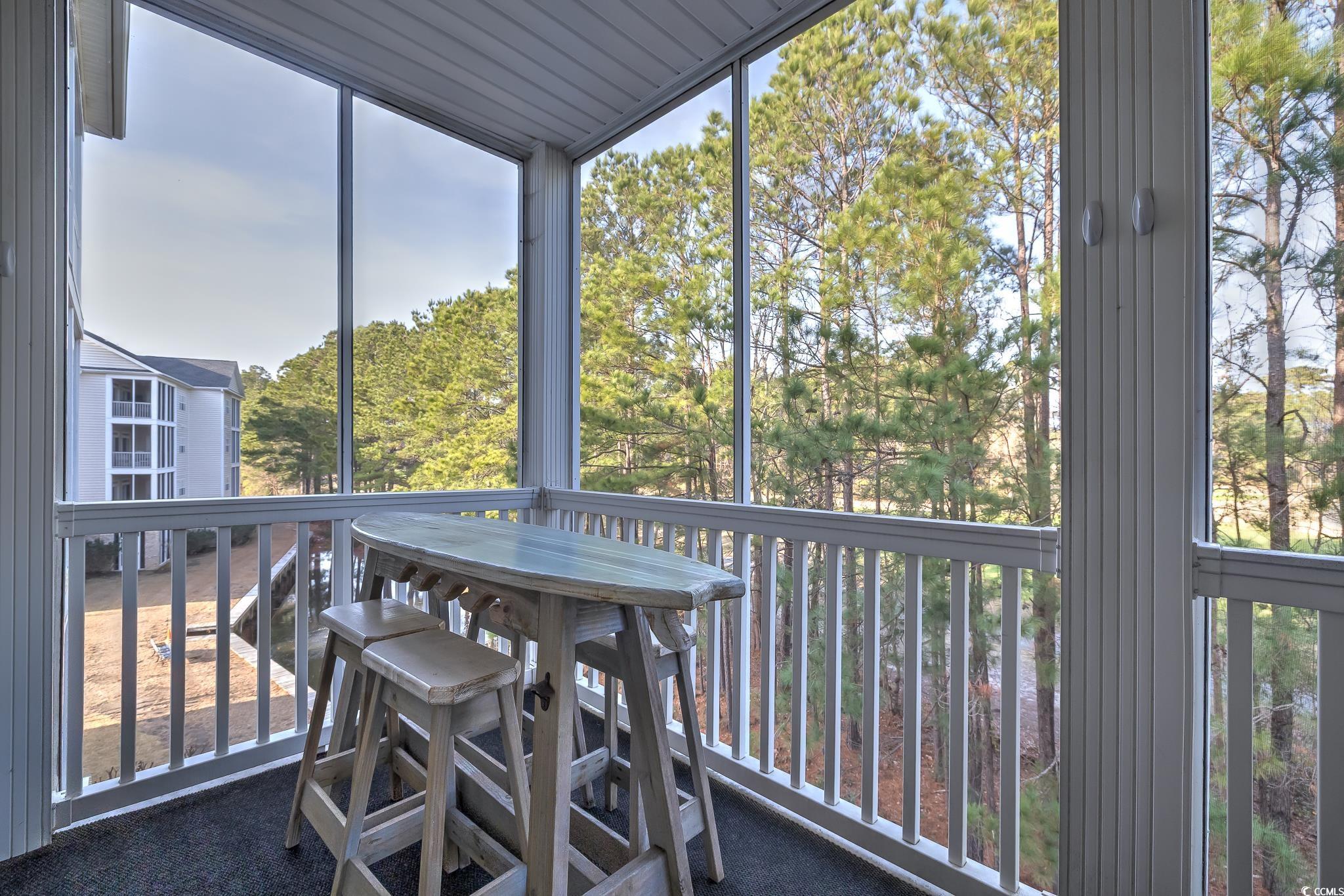 719 Shearwater Court, Unit 303 Murrells Inlet, SC 29576 - Photo 16 of 20 Sunroom featuring view of scattered trees