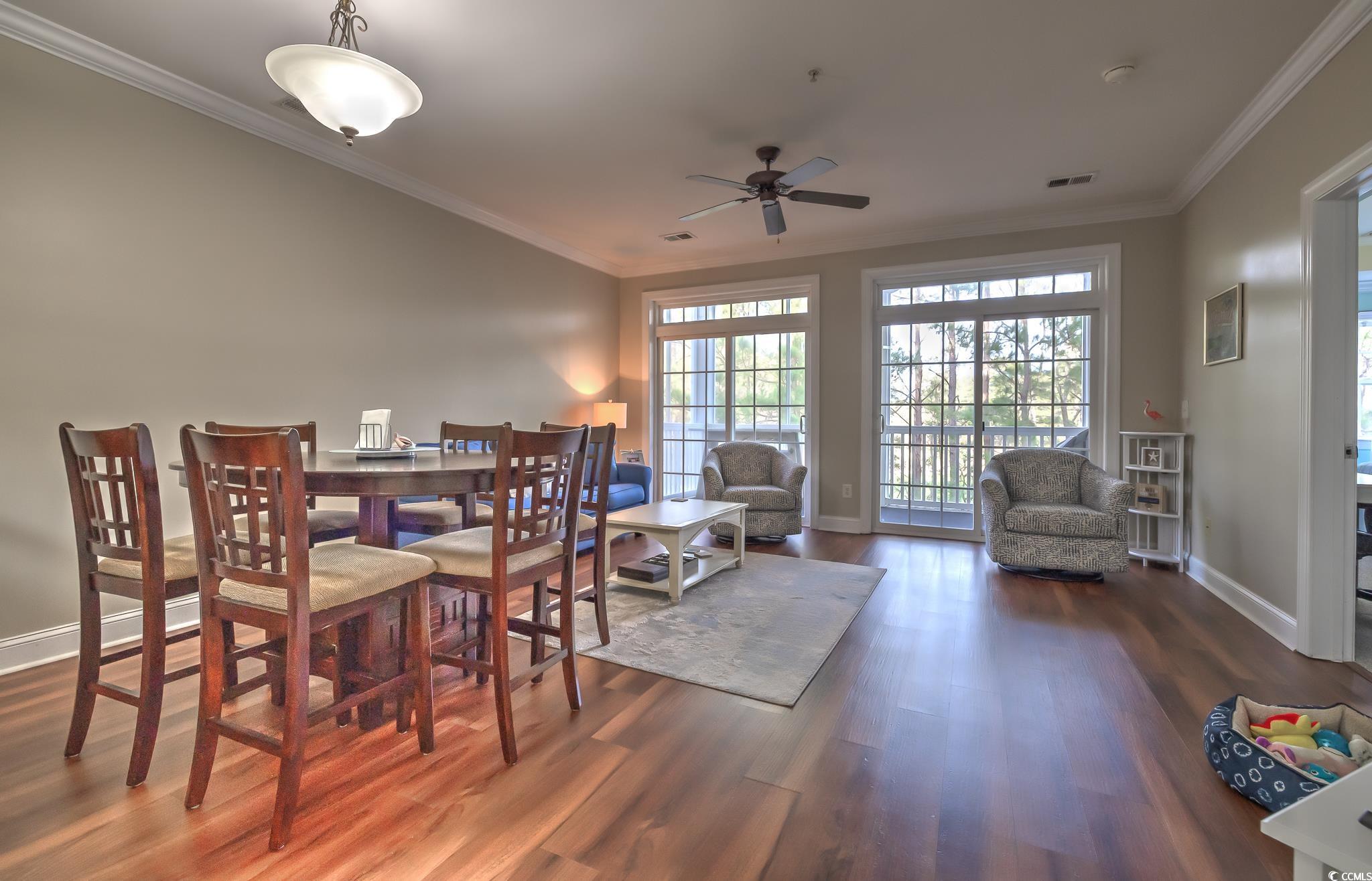 719 Shearwater Court, Unit 303 Murrells Inlet, SC 29576 - Photo 18 of 20 Dining space with crown molding, wood finished floors, and a ceiling fan