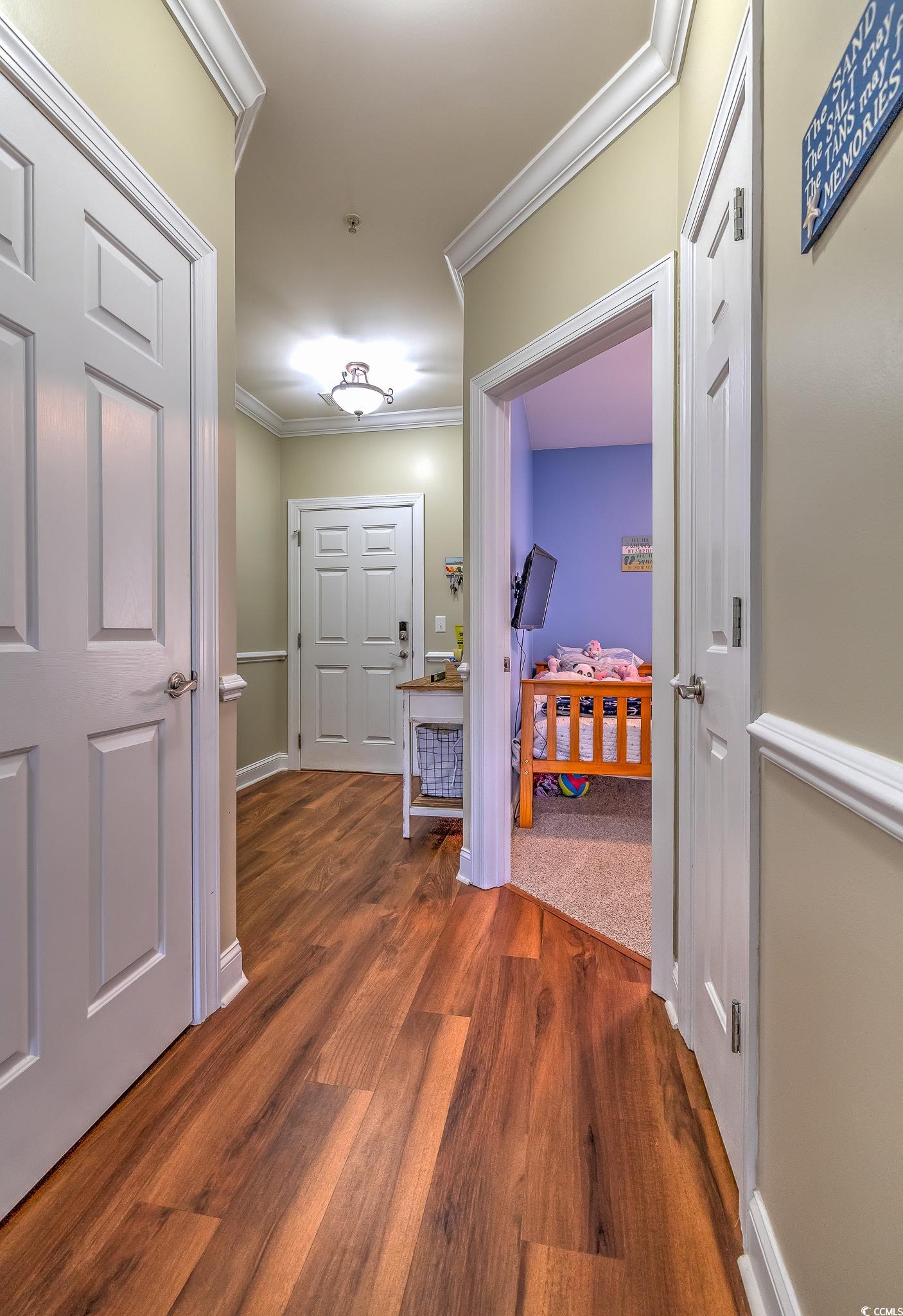719 Shearwater Court, Unit 303 Murrells Inlet, SC 29576 - Photo 9 of 20 Hall featuring crown molding and dark wood-style flooring