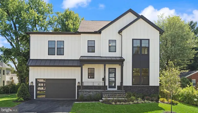 a view of a livingroom with wooden floor and a bathroom
