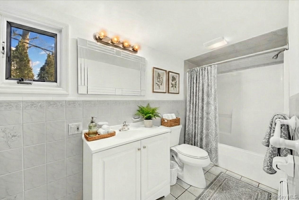 3843 Perry Street Jefferson Valley, NY 10535 - Photo 11 of 36 a bathroom with a sink a toilet and shower