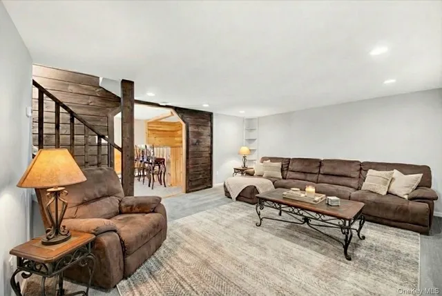 a living room with furniture and a lamp