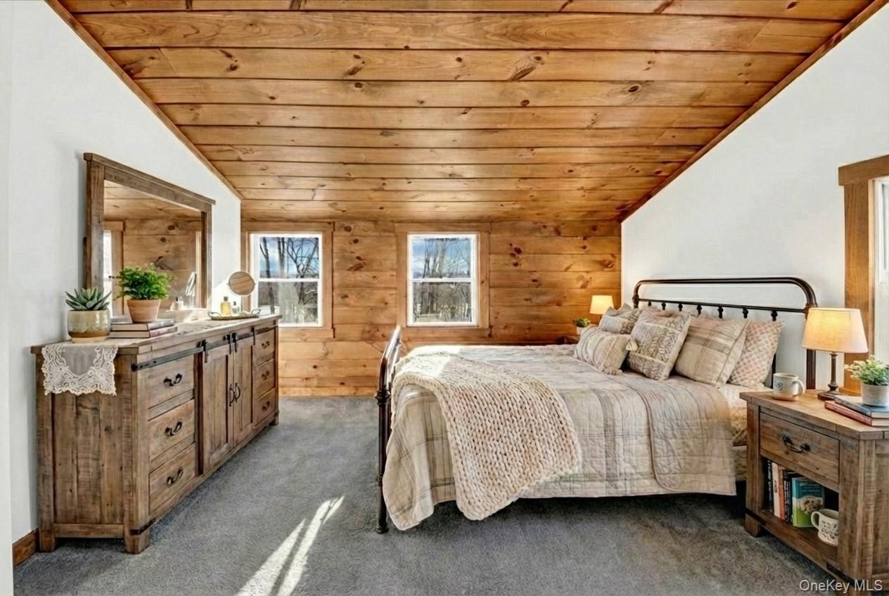 3843 Perry Street Jefferson Valley, NY 10535 - Photo 26 of 36 a bedroom with a large bed and a chandelier