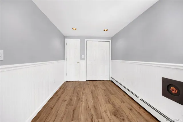 a view of a room with wooden floor