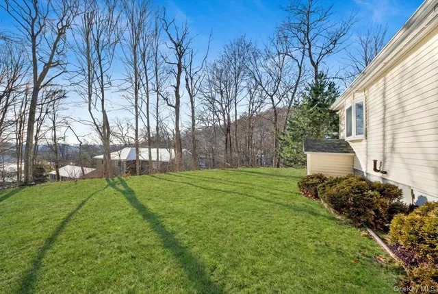 a view of house with a big yard