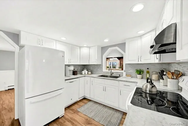 a kitchen with a sink a stove and cabinets