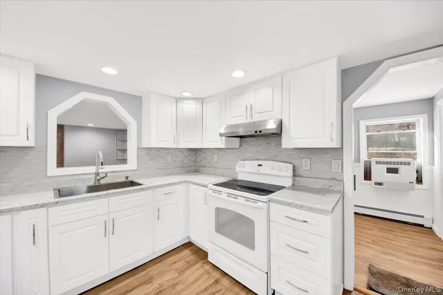 a kitchen with a sink stove and cabinets