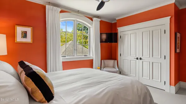 a living room with a black white checkered floor with a gaming machine and dining table