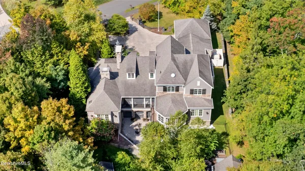 an aerial view of a house with swimming pool and garden space