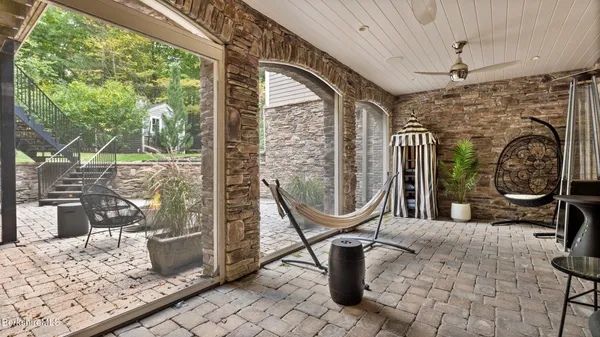 a bedroom with a bed a table and windows