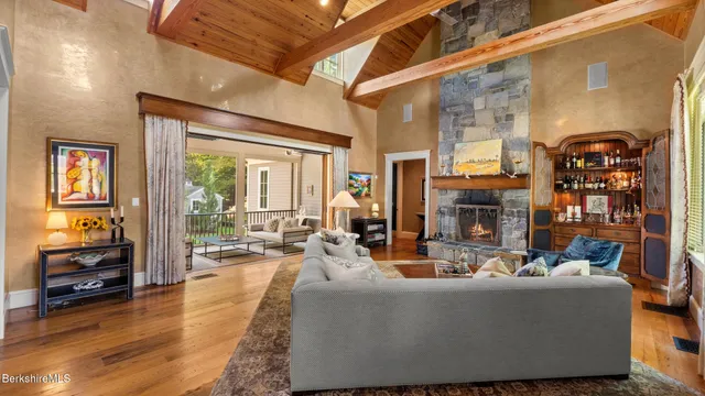 a living room with fireplace furniture and a large window