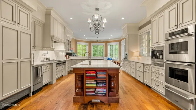a kitchen with cabinets and wooden floor
