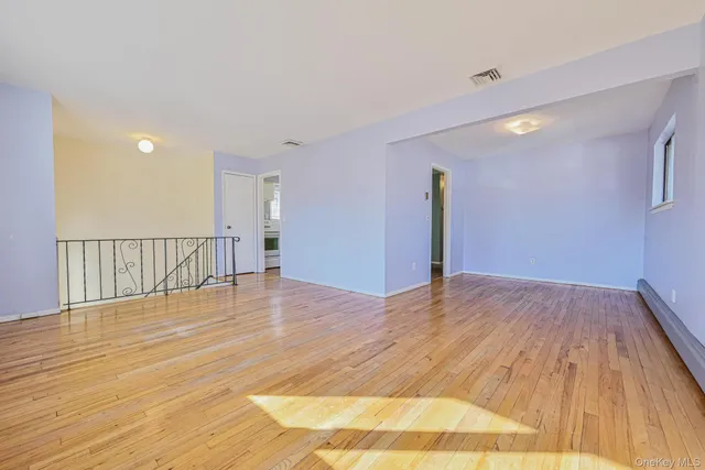 a view of a room with wooden floor