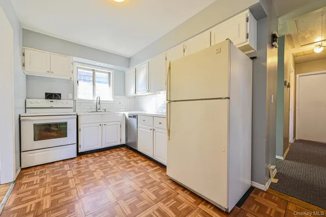 a white refrigerator freezer sitting inside of a kitchen