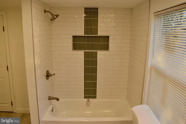 a bathroom with a shower and a bathtub