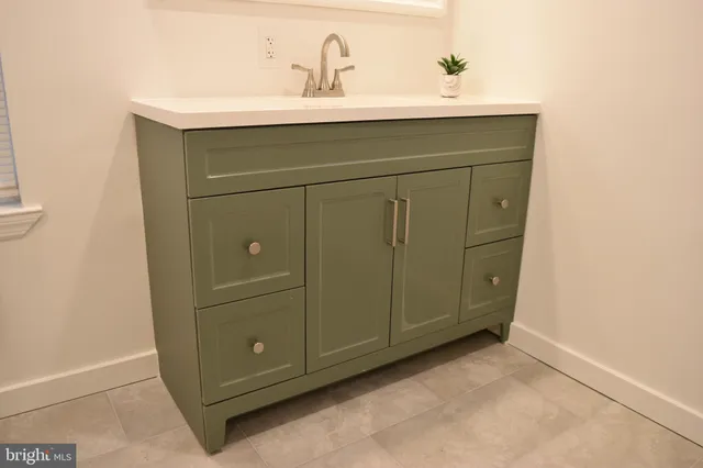 a bathroom with a sink and mirror