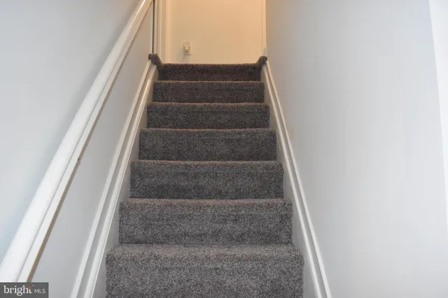 a view of staircase with white walls