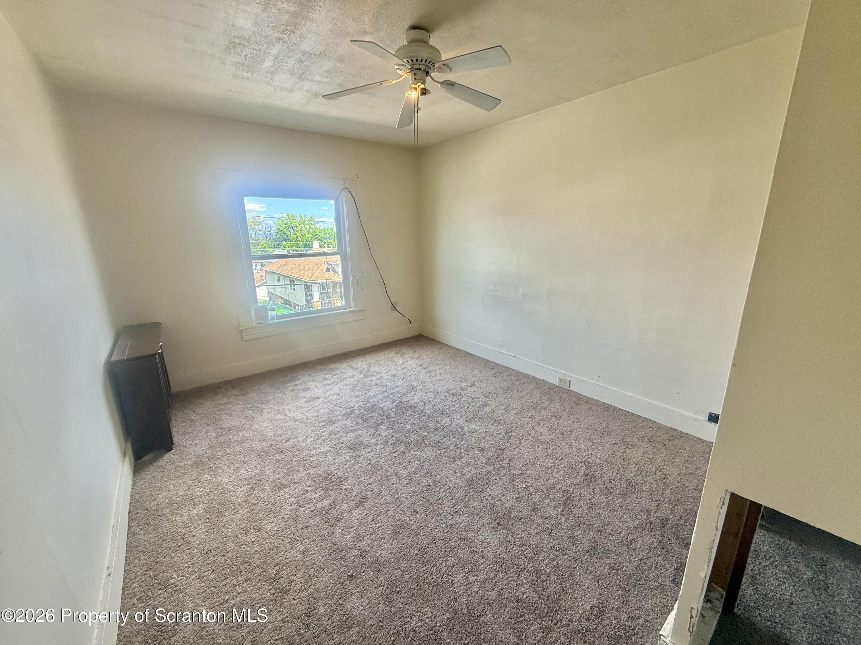 1315 Farr Street, Unit 2 Scranton, PA 18504 - Photo 4 of 7 an empty room with windows and fan