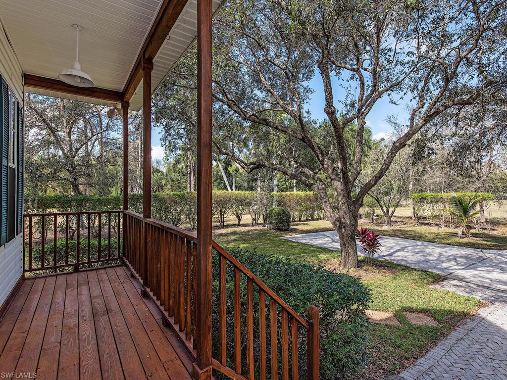 6470 Daniels Road Naples, FL 34109 - Photo 12 of 22 a view of a wooden deck next to a yard