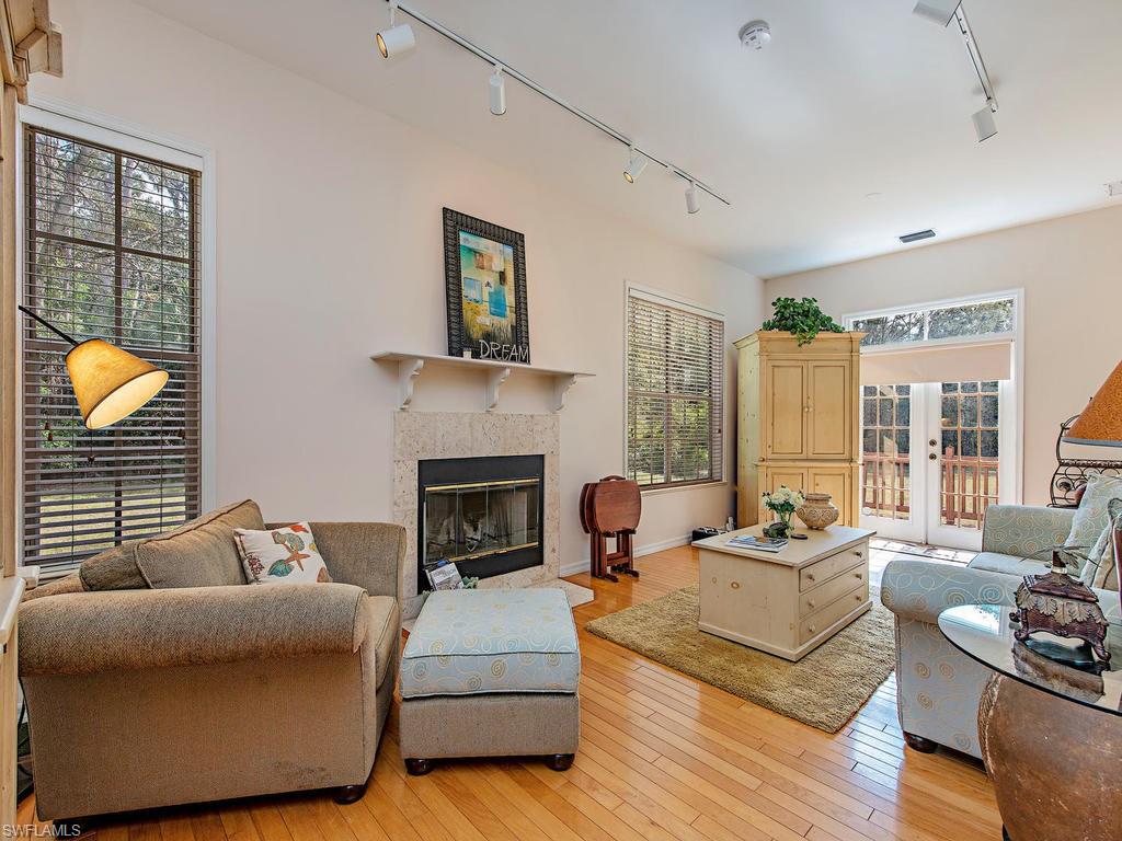 6470 Daniels Road Naples, FL 34109 - Photo 13 of 22 a living room with furniture or couch and a fireplace