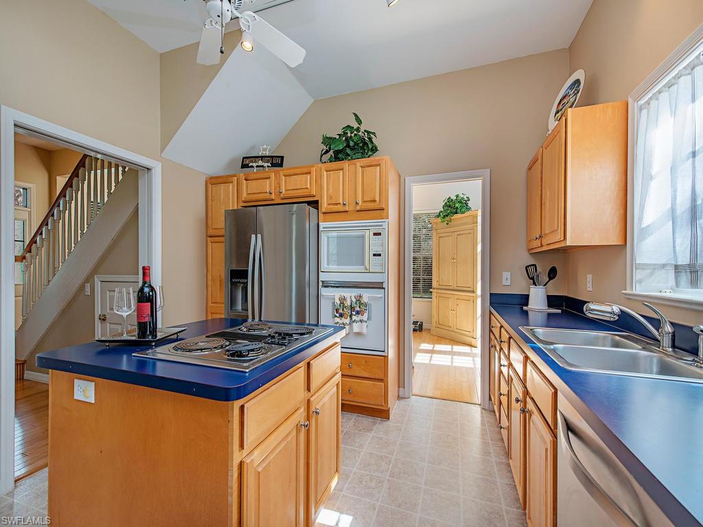6470 Daniels Road Naples, FL 34109 - Photo 14 of 22 a kitchen with stainless steel appliances granite countertop a sink stove and refrigerator