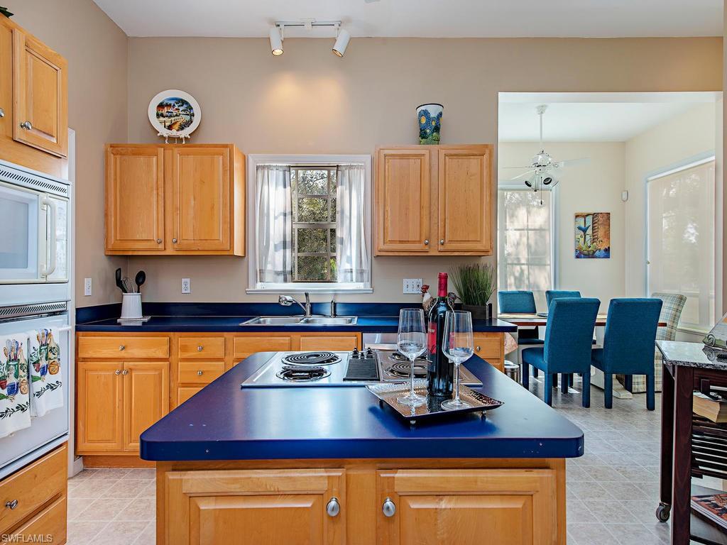 6470 Daniels Road Naples, FL 34109 - Photo 15 of 22 a kitchen with a dining table and chairs