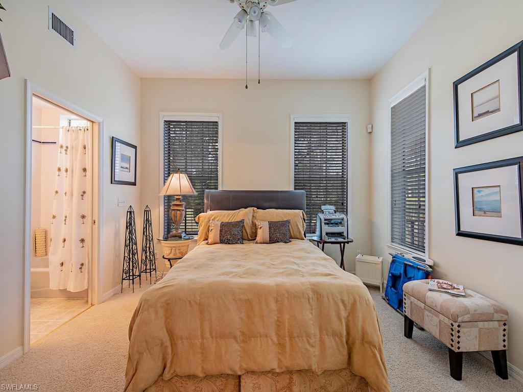 6470 Daniels Road Naples, FL 34109 - Photo 19 of 22 a bedroom with a bed and a chandelier