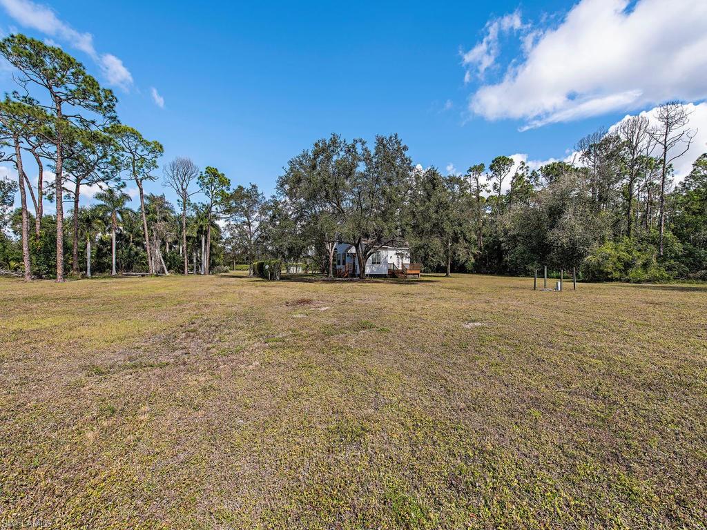 6470 Daniels Road Naples, FL 34109 - Photo 21 of 22 a view of outdoor space with trees all around