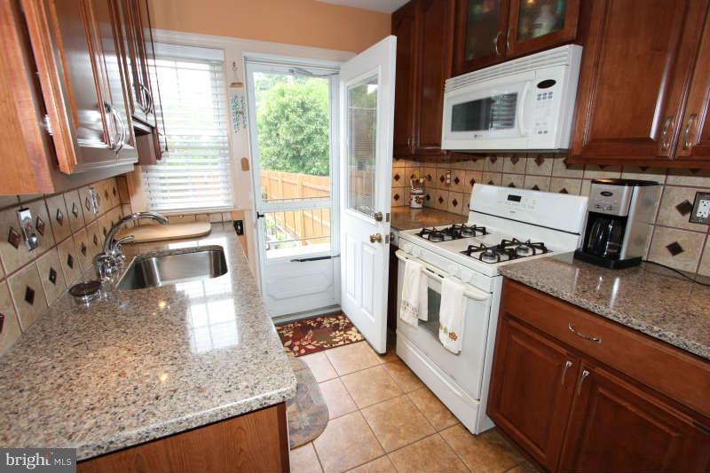 1843 Deveron Road Baltimore, MD 21286 - Photo 3 of 30 a kitchen with stainless steel appliances granite countertop a stove a sink and a microwave