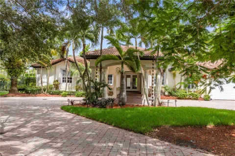 a view of a house with a tree and a yard