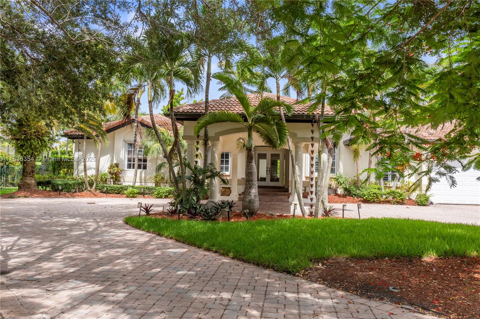 a view of a house with a tree and a yard