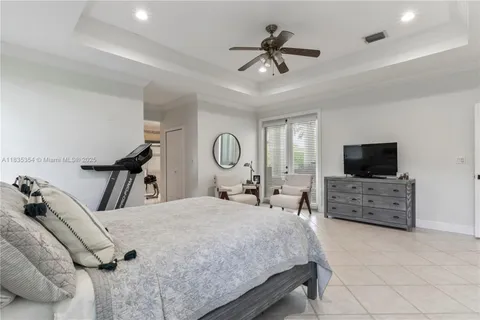 a bed room with a bed a television and dresser