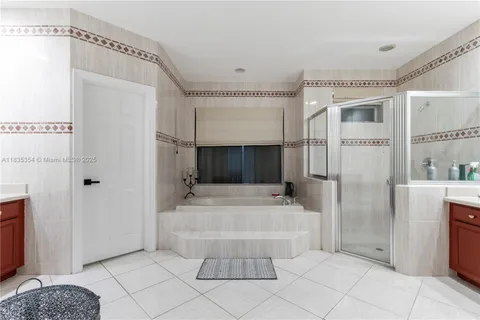 a spacious bathroom with a tub and shower