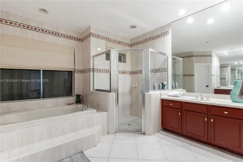 a spacious bathroom with a tub shower and sink