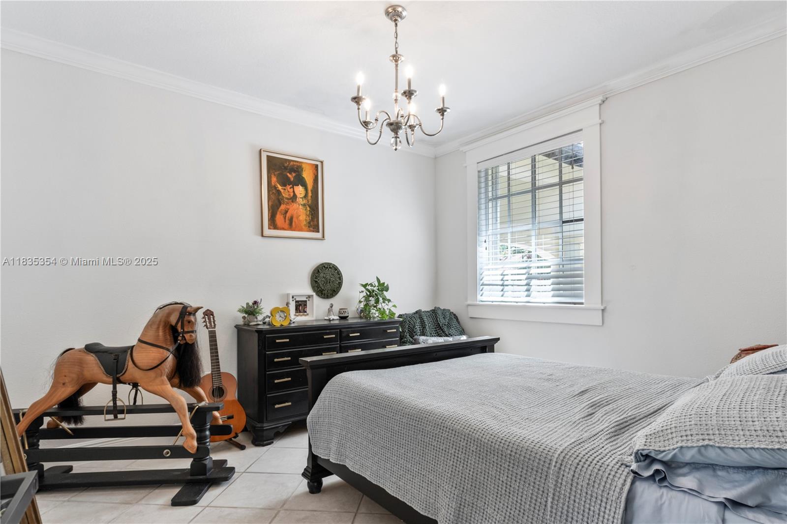 12530 Southwest 96th Court Miami, FL 33176 - Photo 17 of 21 a bedroom with a bed and a chandelier