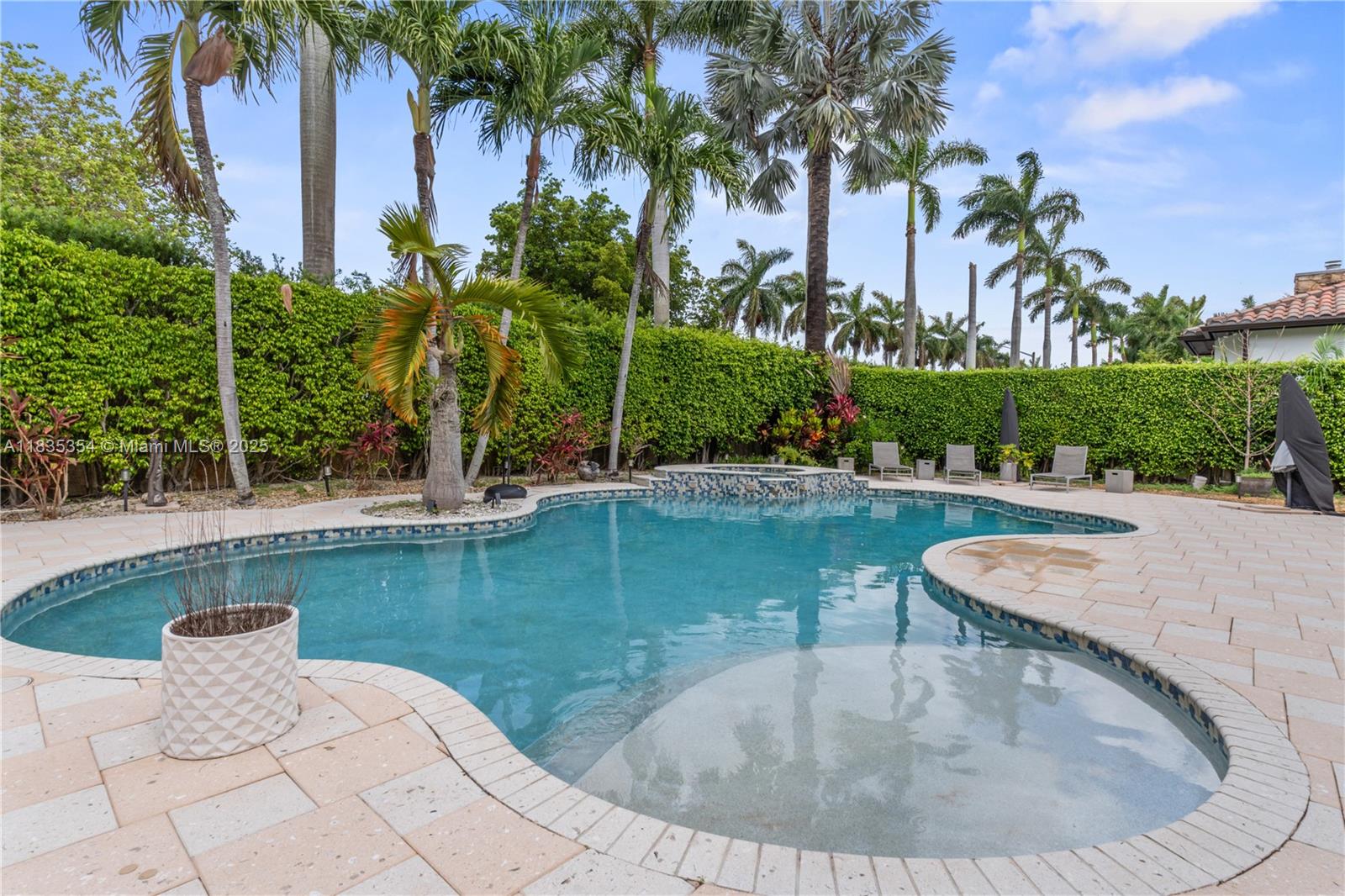 12530 Southwest 96th Court Miami, FL 33176 - Photo 19 of 21 a view of a swimming pool with outdoor seating and plants