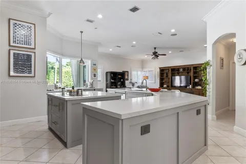 a kitchen with stainless steel appliances granite countertop a sink and a refrigerator