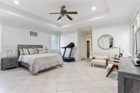 a bedroom with bed and a chandelier