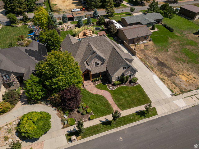 687 South 2080th Street East Springville, UT 84663 - Photo 68 of 149 Multi-level residence featuring a stone and siding exterior, a patterned concrete driveway, and a curved paver walkway leading to the entrance