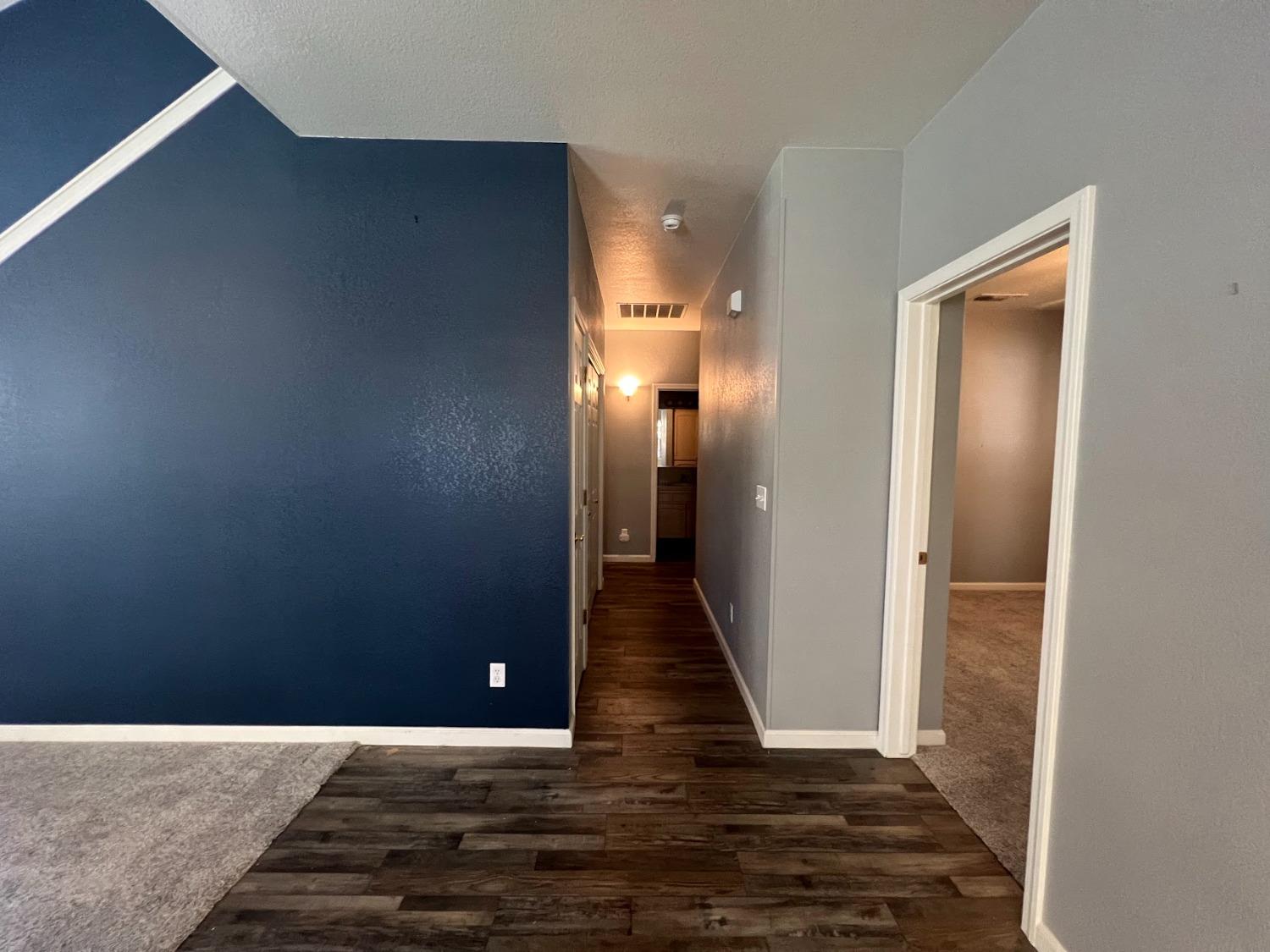 Undisclosed Address Dinuba, CA 93618 - Photo 15 of 45 a view of a hallway with wooden floor