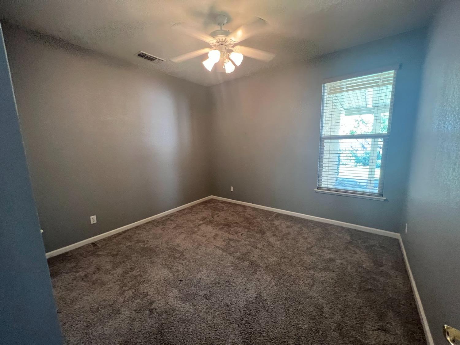 Undisclosed Address Dinuba, CA 93618 - Photo 16 of 45 an empty room with windows and fan