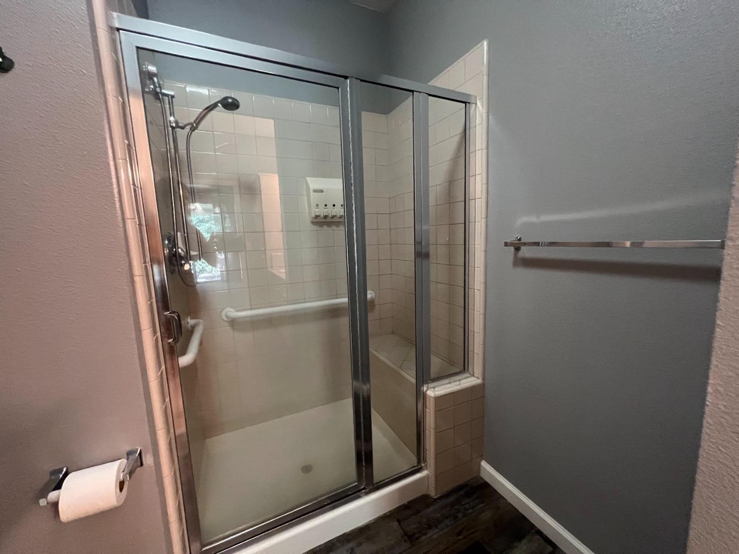 Undisclosed Address Dinuba, CA 93618 - Photo 23 of 45 a bathroom with a glass shower door and sink