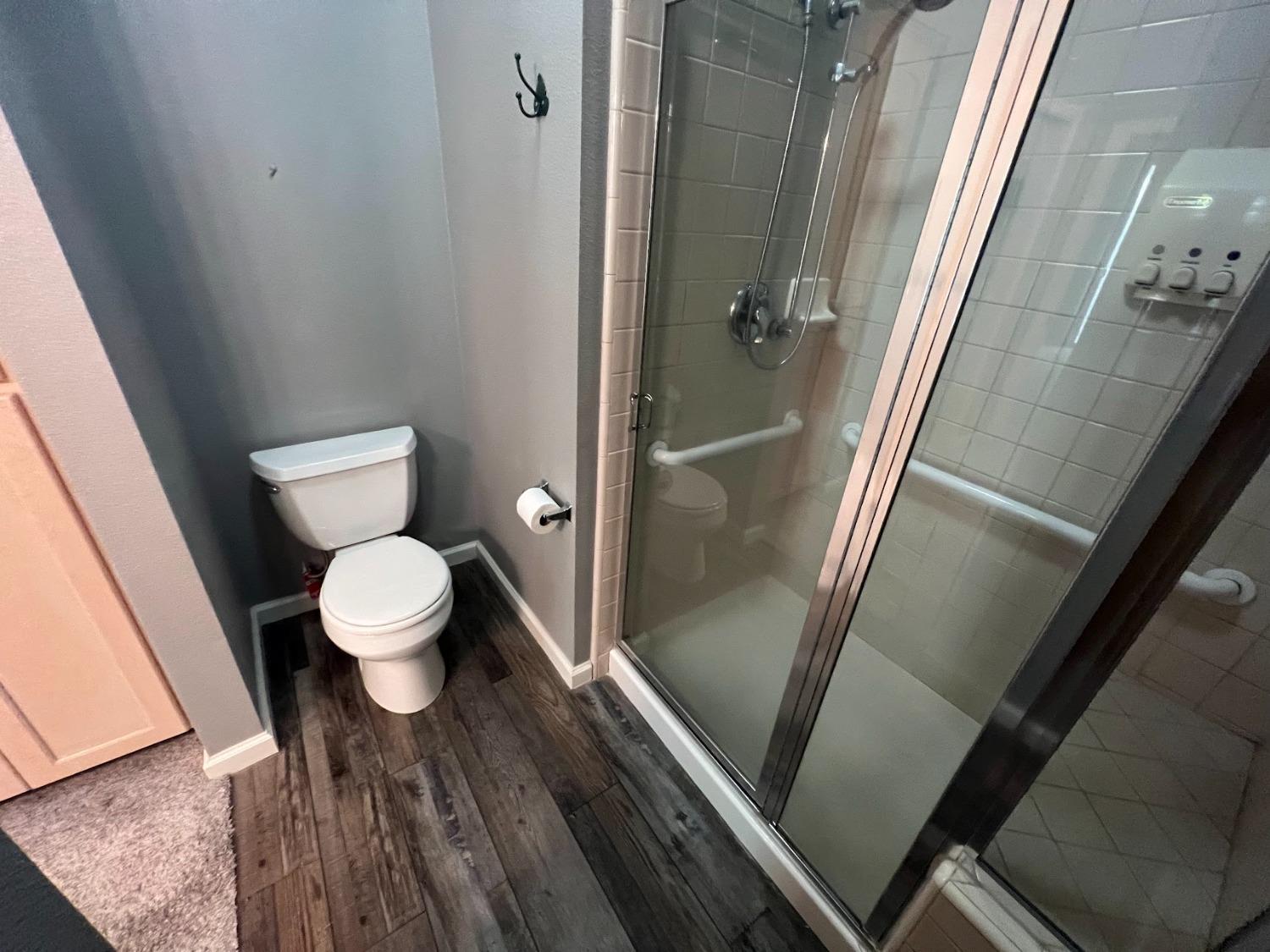 Undisclosed Address Dinuba, CA 93618 - Photo 24 of 45 a bathroom with a toilet and a shower