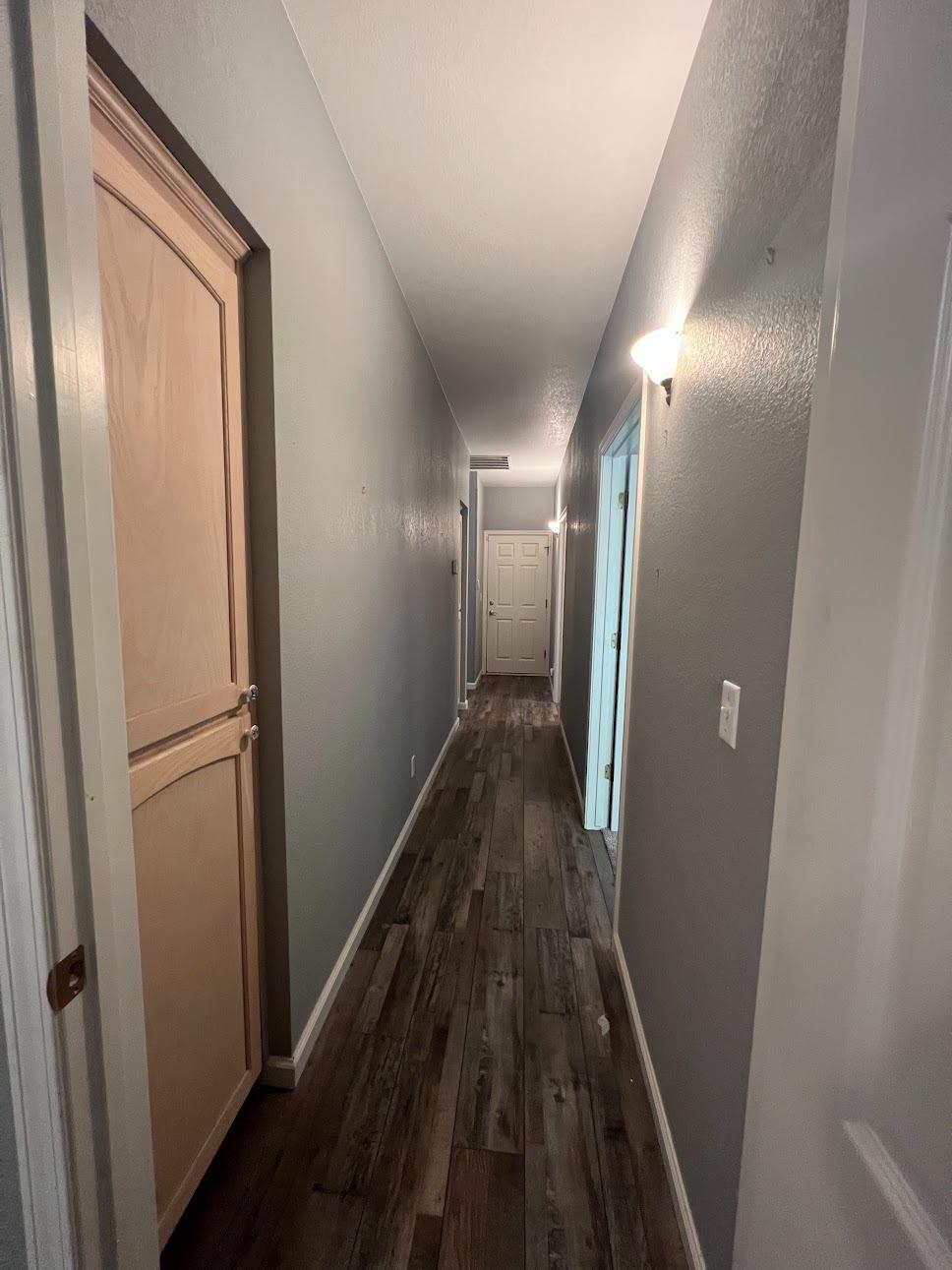 Undisclosed Address Dinuba, CA 93618 - Photo 28 of 45 a view of a hallway with wooden floor